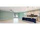 Open-concept living room and kitchen featuring stainless steel appliances and a kitchen island at 1180 Lone Palm Way, St Cloud, FL 34771