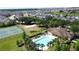 Wide aerial view of neighborhood amenities including pool, clubhouse, volleyball court and tennis courts at 1271 Yorkshire Ct, Davenport, FL 33896