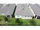 Aerial view of backyard featuring green grass, a black fence, and a covered patio at 1271 Yorkshire Ct, Davenport, FL 33896