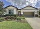 Beautiful one-story home featuring a manicured lawn and an attached two-car garage at 1271 Yorkshire Ct, Davenport, FL 33896
