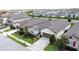 Aerial view of a house with a two-car garage, manicured landscaping, and a paved driveway at 1271 Yorkshire Ct, Davenport, FL 33896