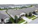 Aerial view of a house with a two-car garage, manicured landscaping, and a driveway at 1271 Yorkshire Ct, Davenport, FL 33896