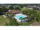 Aerial view of outdoor pool with lounge chairs and landscaped area next to community center at 1271 Yorkshire Ct, Davenport, FL 33896