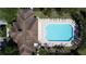 Aerial view of a pool and community building with lounge chairs and landscaping at 1271 Yorkshire Ct, Davenport, FL 33896