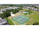 Aerial view of community tennis courts and clubhouse with swimming pool, surrounded by lush landscaping and residential homes at 1271 Yorkshire Ct, Davenport, FL 33896
