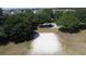 Outdoor sand volleyball court with net and parking area, surrounded by shade trees at 1271 Yorkshire Ct, Davenport, FL 33896