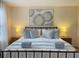 Comfortable bedroom featuring a queen size bed with matching side tables and lamps at 141 Summer Place Loop, Clermont, FL 34714