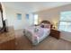 Cozy bedroom featuring a queen bed, dresser, and natural light at 141 Summer Place Loop, Clermont, FL 34714
