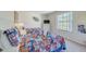 Bright bedroom features sport-themed decor, cozy bedding, and a large window at 141 Summer Place Loop, Clermont, FL 34714