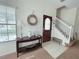 Inviting entryway featuring a wood door, decorative accents, and staircase leading to the upper level at 141 Summer Place Loop, Clermont, FL 34714