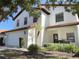 Beautiful two-story home with red tile roof, manicured landscaping, and an attached two car garage at 141 Summer Place Loop, Clermont, FL 34714