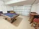 Game room features a pool table, table, and foosball game in garage at 141 Summer Place Loop, Clermont, FL 34714
