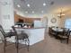 Bright eat-in kitchen featuring modern decor and space for both cooking and dining at 141 Summer Place Loop, Clermont, FL 34714