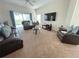 Bright living room boasts lots of comfortable seating, modern TV, and plenty of natural light from windows at 141 Summer Place Loop, Clermont, FL 34714