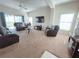 Spacious living room with comfortable seating, vaulted ceiling, and sliding glass doors to the outdoor area at 141 Summer Place Loop, Clermont, FL 34714
