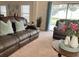 Cozy living room with views of the backyard pool area and comfortable furniture for relaxing at 141 Summer Place Loop, Clermont, FL 34714