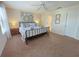 Spacious main bedroom with a ceiling fan and view into the ensuite bath at 141 Summer Place Loop, Clermont, FL 34714