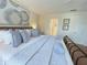 Bright main bedroom featuring a large bed with decorative pillows and bedside tables at 141 Summer Place Loop, Clermont, FL 34714