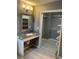 Bathroom featuring a granite vanity and walk-in closet with built-in shelving at 1512 Ison Ln, Ocoee, FL 34761