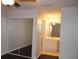 Bright bedroom features a spacious mirrored closet and a view of the adjacent bathroom at 2804 Club Cortile Cir # A, Kissimmee, FL 34746