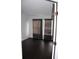 A bedroom with hardwood floors, black out curtains and a door at 2804 Club Cortile Cir # A, Kissimmee, FL 34746