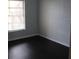 Small bedroom with a window and hardwood floors at 2804 Club Cortile Cir # A, Kissimmee, FL 34746