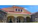 Charming clubhouse exterior with stone accents and a tiled roof, a welcoming community gathering space at 2804 Club Cortile Cir # A, Kissimmee, FL 34746