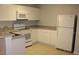 Kitchen with white appliances, cabinets and a sink at 2804 Club Cortile Cir # A, Kissimmee, FL 34746