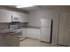 Kitchen with white appliances and lots of storage at 2804 Club Cortile Cir # A, Kissimmee, FL 34746