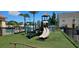 Inviting community playground with climbing structures and slides, surrounded by lush green turf at 2804 Club Cortile Cir # A, Kissimmee, FL 34746