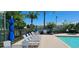 Relaxing pool area featuring lounge chairs and umbrellas, offering a perfect spot to unwind on a sunny day at 2804 Club Cortile Cir # A, Kissimmee, FL 34746