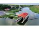 Aerial view of a boat house and community recreation center located on a lake at 3600 Harbor Isles Ct, Kissimmee, FL 34746