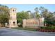 A beautiful entrance to Bellalago with stone tower, sign and flowers at 3600 Harbor Isles Ct, Kissimmee, FL 34746
