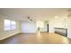 Spacious living room with hardwood floors, a ceiling fan, and natural light from the large window at 3600 Harbor Isles Ct, Kissimmee, FL 34746