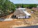 Aerial view of the single-story home, white fence, and a detached garage in a residential area at 629 N 7Th St, Lake Wales, FL 33853