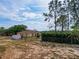 Large, fenced backyard with lush trees, providing a private and serene outdoor space at 629 N 7Th St, Lake Wales, FL 33853