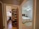 View into bedrooms with wood floors, one with a storage unit, the other with a ceiling fan at 629 N 7Th St, Lake Wales, FL 33853
