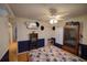 A cozy bedroom featuring a ceiling fan, fireplace, and wood-look flooring at 629 N 7Th St, Lake Wales, FL 33853