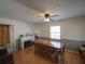 Dining room features a brick fireplace, a long wooden table and view of an open doorway at 629 N 7Th St, Lake Wales, FL 33853