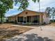 Charming single-story home with a red star, screened-in porch, and a well-maintained front yard at 629 N 7Th St, Lake Wales, FL 33853