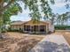 Charming single-story home featuring a screened-in porch and a spacious front yard with mature trees at 629 N 7Th St, Lake Wales, FL 33853