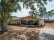 Charming single-story home with mature trees and a screened front porch at 629 N 7Th St, Lake Wales, FL 33853