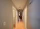 Hallway featuring hardwood flooring with views into different rooms at 629 N 7Th St, Lake Wales, FL 33853