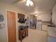 Bright kitchen featuring white cabinets, stainless steel appliances, and a view to an adjacent room at 629 N 7Th St, Lake Wales, FL 33853