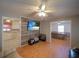 Open-concept living space featuring wood-look floors and a large television at 629 N 7Th St, Lake Wales, FL 33853