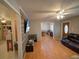 Inviting living room with wood floors, ceiling fan and comfortable leather sofa at 629 N 7Th St, Lake Wales, FL 33853