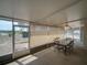 View of the enclosed patio with a glass table and chairs, screened windows, and a ceiling fan at 629 N 7Th St, Lake Wales, FL 33853