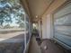 Covered front porch offering outdoor living space with screens, seating and curb appeal at 629 N 7Th St, Lake Wales, FL 33853