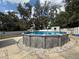 This fenced backyard features a lovely above-ground pool, perfect for summer fun and relaxation at 6922 Doehring Dr, Lakeland, FL 33810