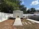 Backyard shed with a ramp, accompanied by an above ground pool and a white vinyl fence at 6922 Doehring Dr, Lakeland, FL 33810